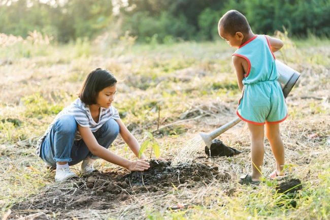 two-children-planting-trees-eco-environment-concept_34152-2478