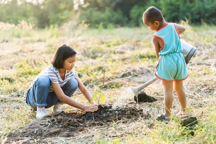 two-children-planting-trees-eco-environment-concept_34152-2478